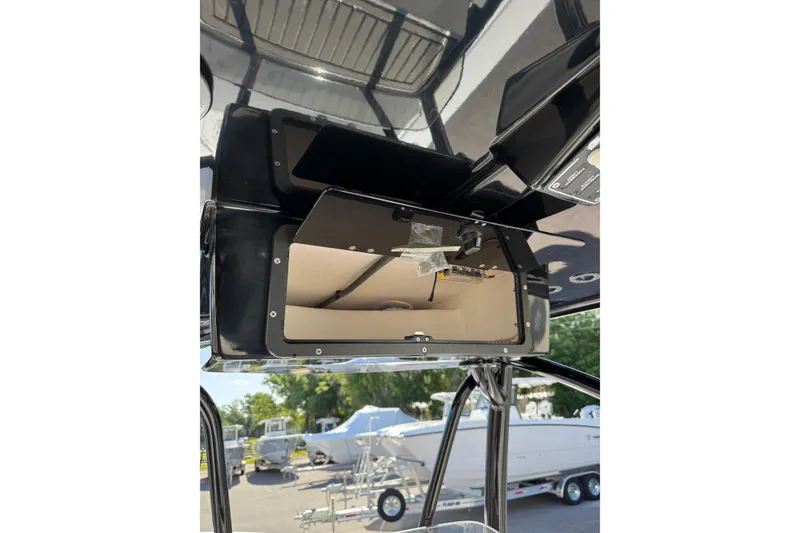 Slide: The Image of Open storage compartments on a 2026 BlackJack 256 Coastal boat deck. - 18