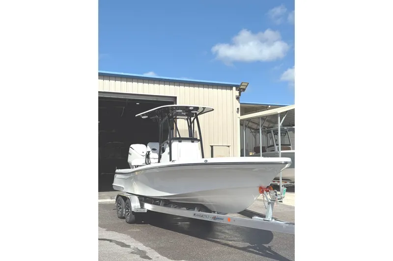 Slide: The Image of 2026 BlackJack 256 Coastal boat on trailer, parked outdoors under a blue sky. - 2