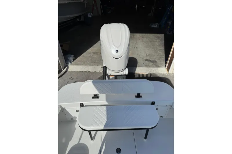 Slide: The Image of 2026 BlackJack 256 Coastal boat with Yamaha outboard motor in a marina setting. - 21