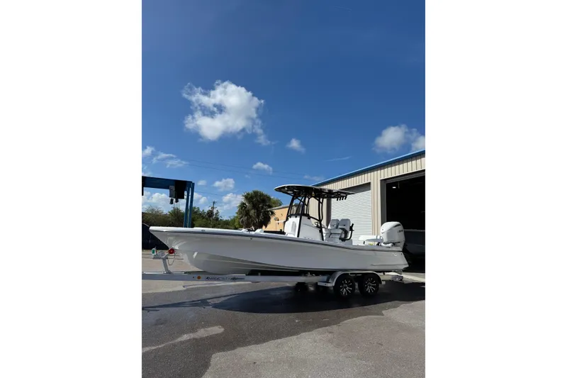 Slide: The Image of 2026 BlackJack 256 Coastal boat on trailer, parked outside a building. - 3