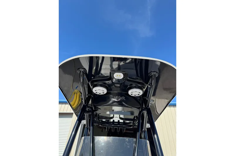 Slide: The Image of 2026 BlackJack 256 Coastal boat with powerful 350 V6 engine, parked outdoors. - 7