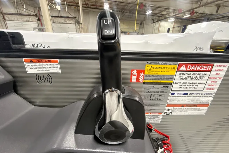 Slide: The Image of Throttle control and safety warnings on a 2026 Bennington 22 S Swingback boat. - 13