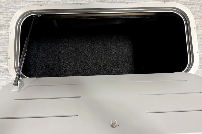 Slide: The Image of Storage compartment of 2026 Bennington 22 S Swingback boat, open with visible interior. - 16