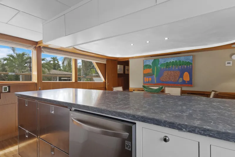 Slide: The Image of Luxurious yacht interior with modern kitchen, marble countertop, and vibrant artwork, Burger 1985 model. - 10