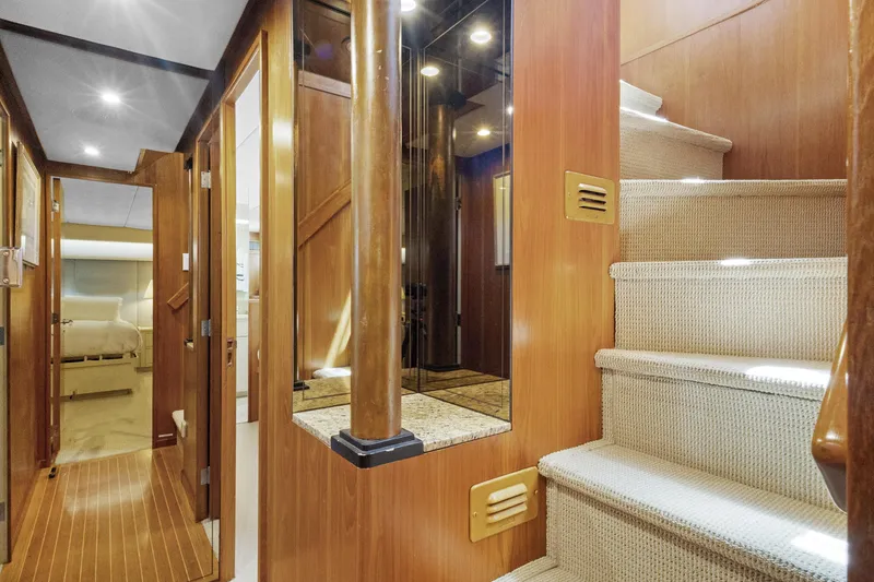 Slide: The Image of Interior of a 1985 Burger yacht featuring wooden stairs and hallway. - 11