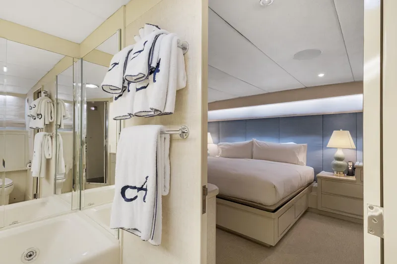 Slide: The Image of Luxurious yacht bedroom and bathroom with elegant decor, featuring plush bedding and soft lighting. - 16