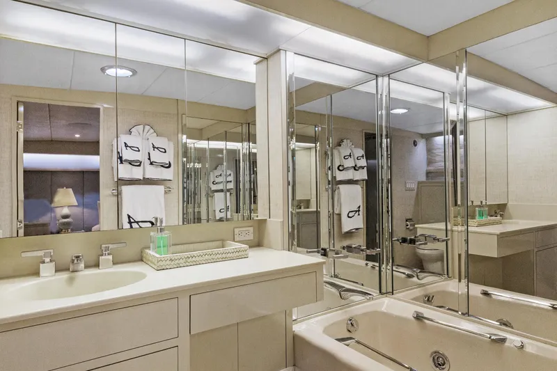 Slide: The Image of Luxurious yacht bathroom with mirrored walls, elegant fixtures, and plush towels, Burger 1985 model. - 17