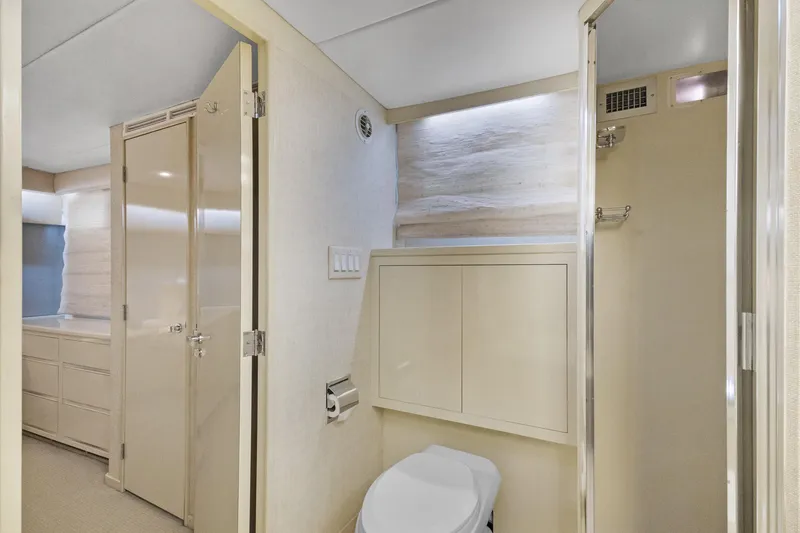 Slide: The Image of Modern bathroom interior in a 1985 Burger model yacht, featuring sleek cabinetry and neutral tones. - 18