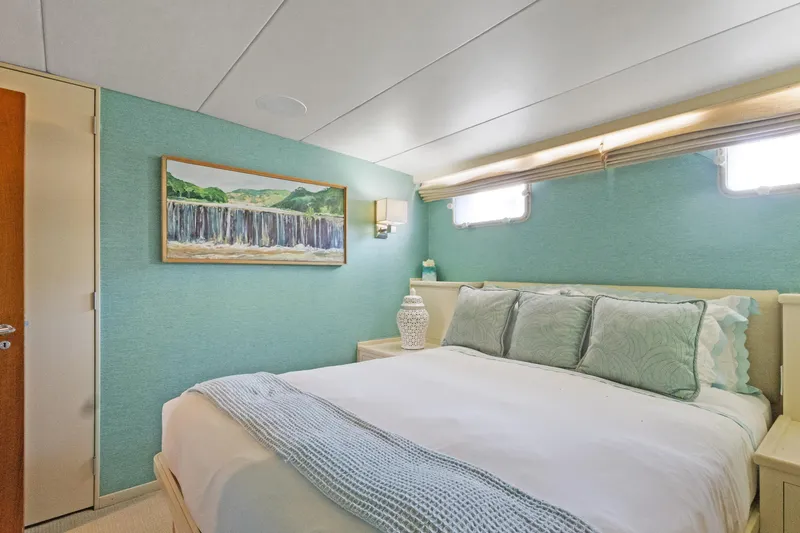 Slide: The Image of Cozy bedroom in 1985 Burger yacht with teal walls and elegant decor. - 19