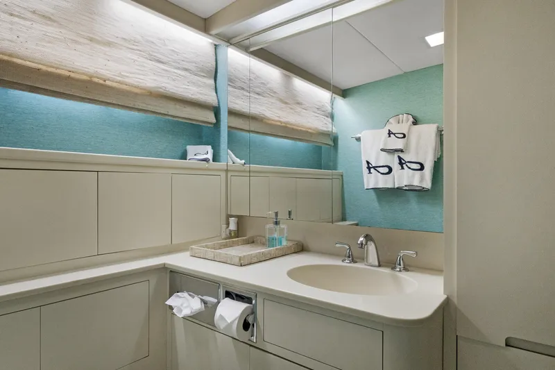 Slide: The Image of Luxurious yacht bathroom with modern fixtures, teal accents, and monogrammed towels, 1985 Burger model. - 22