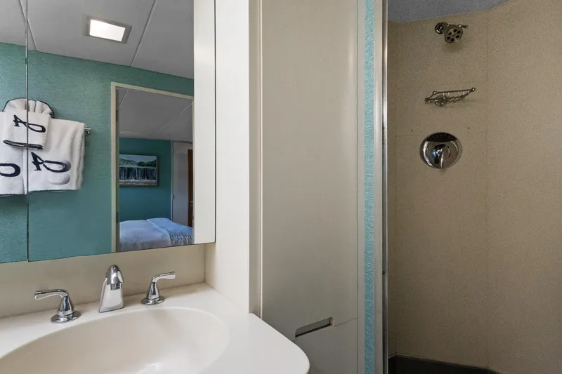 Slide: The Image of Bathroom with modern sink, mirror, and shower in a 1985 Burger model. - 23