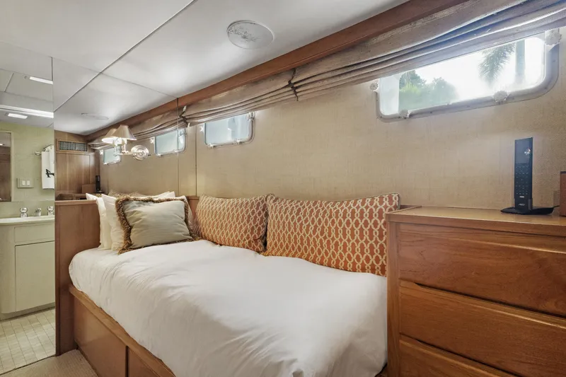 Slide: The Image of Cozy bedroom in 1985 Burger yacht with wooden furniture and nautical decor. - 25