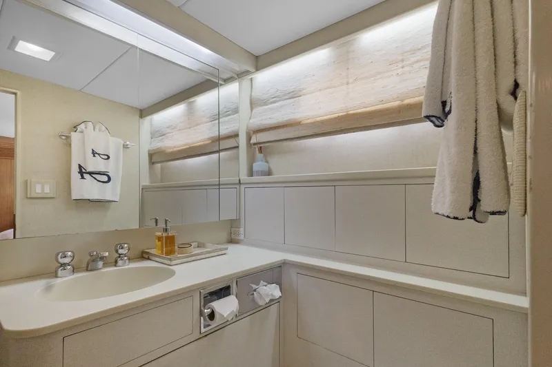 Slide: The Image of Luxurious yacht bathroom with modern fixtures, soft lighting, and elegant towels, 1985 Burger model. - 26