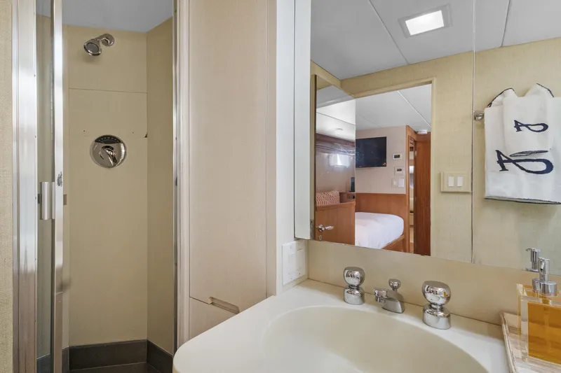 Slide: The Image of Bathroom interior of a 1985 Burger yacht, featuring a shower and sink area. - 27