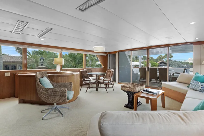 Slide: The Image of Luxurious 1985 Burger yacht interior with elegant seating, large windows, and modern decor. - 3