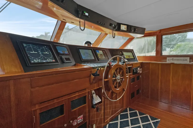 Slide: The Image of Helm of 1985 Burger yacht with wooden wheel and navigation instruments. - 35