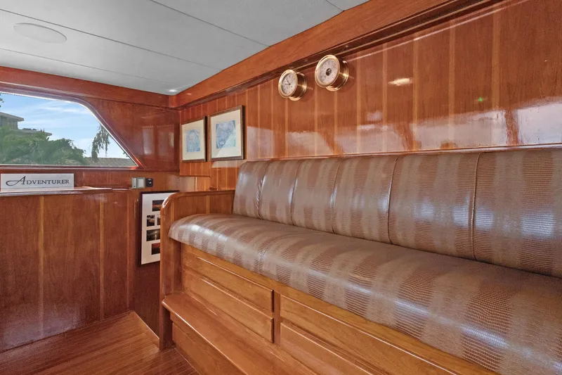 Slide: The Image of Luxurious wooden interior of a 1985 Burger yacht with cushioned seating and nautical decor. - 36