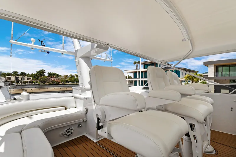 Slide: The Image of Luxury yacht deck with white seating, featuring modern waterfront homes in the background. - 39