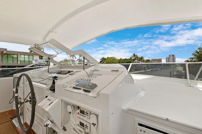 Slide: The Image of Helm of a 1985 Burger yacht with cityscape and blue sky background. - 40