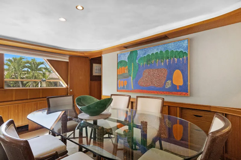 Slide: The Image of Elegant yacht dining area with glass table, modern art, and scenic window view. Burger 1985 model. - 6