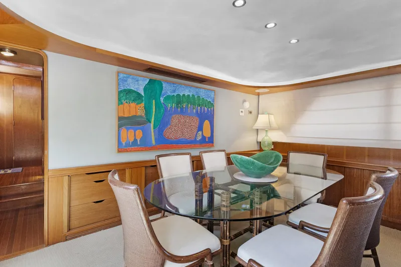 Slide: The Image of Elegant yacht dining area with glass table, modern art, and ambient lighting, 1985 Burger model. - 7