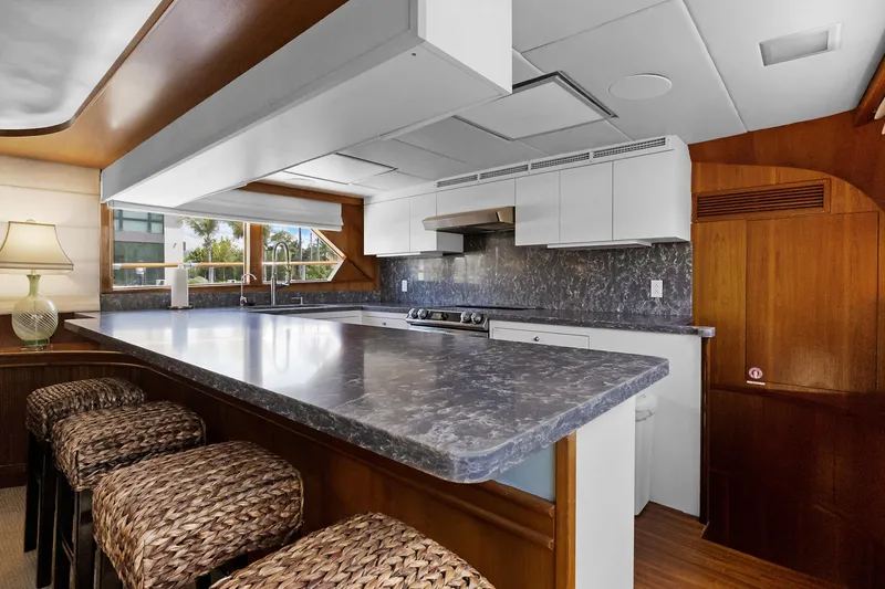 Slide: The Image of Spacious kitchen in 1985 Burger model yacht with marble countertops and wicker stools. - 9