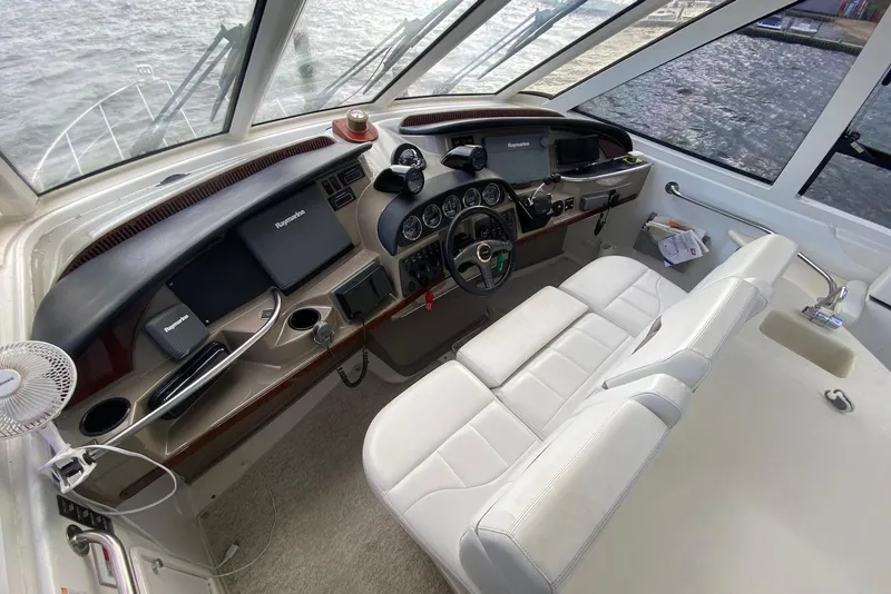 Slide: The Image of Helm of 2000 Carver 506 Motor Yacht with navigation equipment and white seating. - 10
