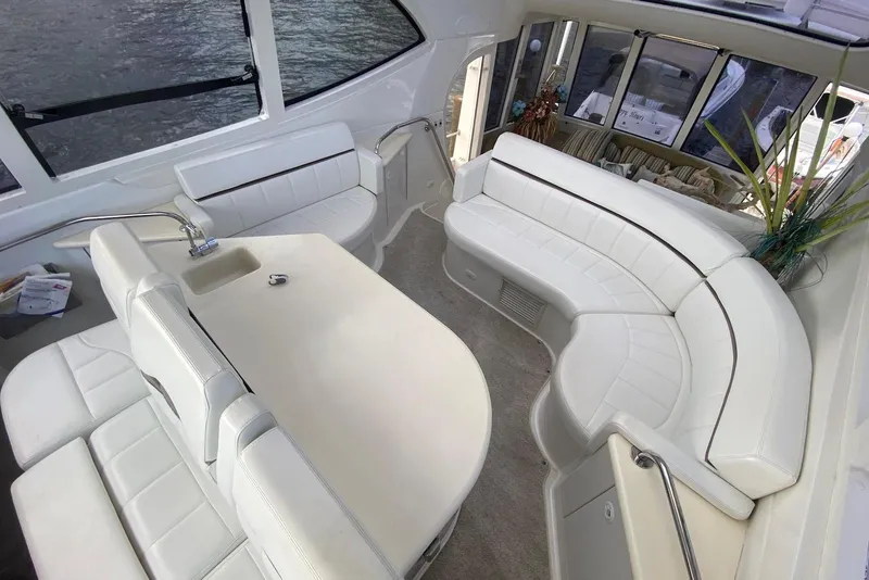 Slide: The Image of Luxurious interior of 2000 Carver 506 Motor Yacht with elegant white seating and table. - 11