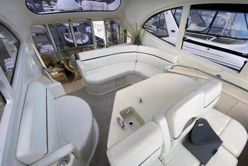 Slide: The Image of Luxurious interior of a 2000 Carver 506 Motor Yacht with white seating and large windows. - 13