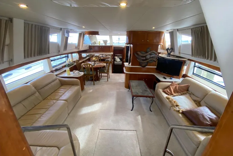 Slide: The Image of Luxurious interior of a 2000 Carver 506 Motor Yacht with elegant seating and dining area. - 16
