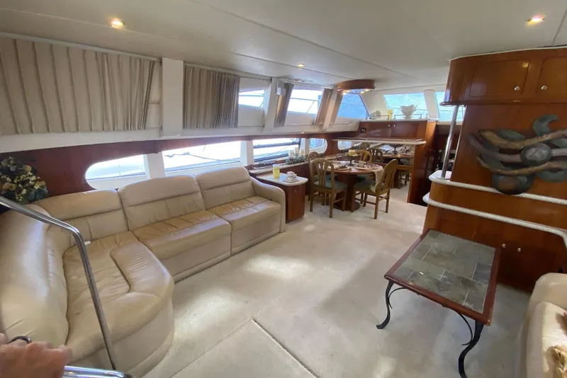 Slide: The Image of Luxurious interior of a 2000 Carver 506 Motor Yacht with elegant seating and dining area. - 17