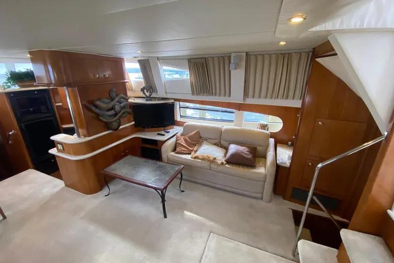 Slide: The Image of Luxurious interior of 2000 Carver 506 Motor Yacht with cozy seating and elegant decor. - 18