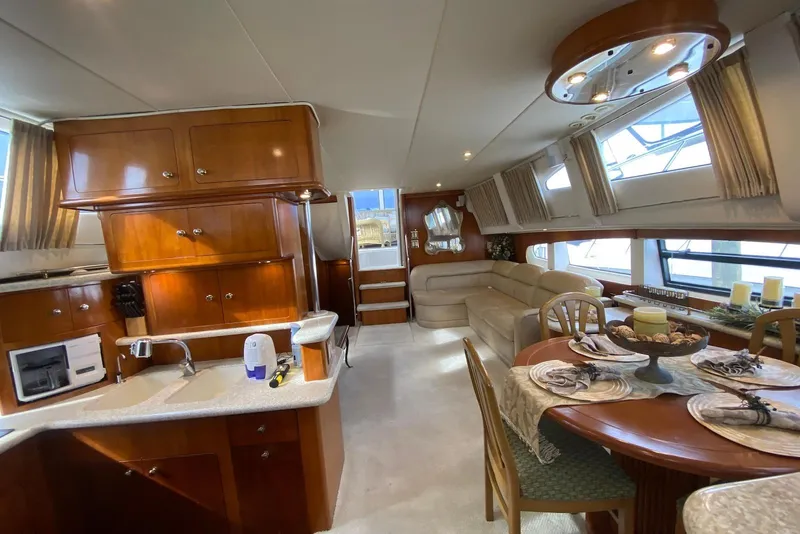 Slide: The Image of Luxurious interior of 2000 Carver 506 Motor Yacht with kitchen and dining area. - 21