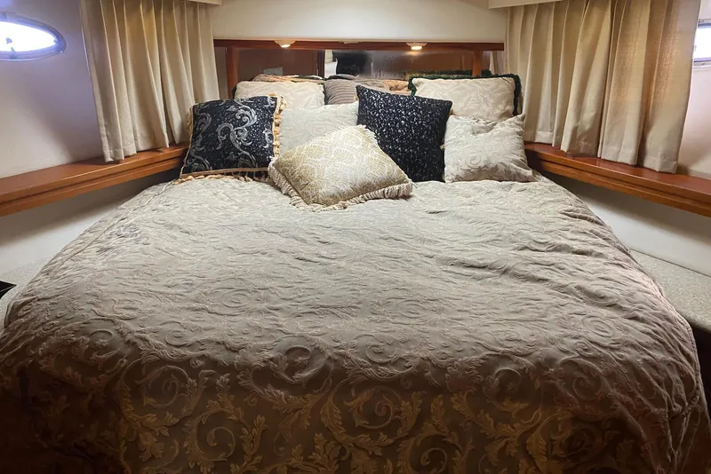 Slide: The Image of Luxurious bedroom interior of 2000 Carver 506 Motor Yacht with elegant bedding and pillows. - 25