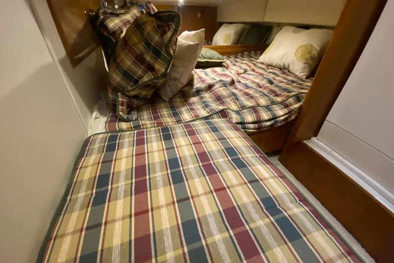Slide: The Image of Cozy cabin interior of 2000 Carver 506 Motor Yacht with plaid bedding. - 27