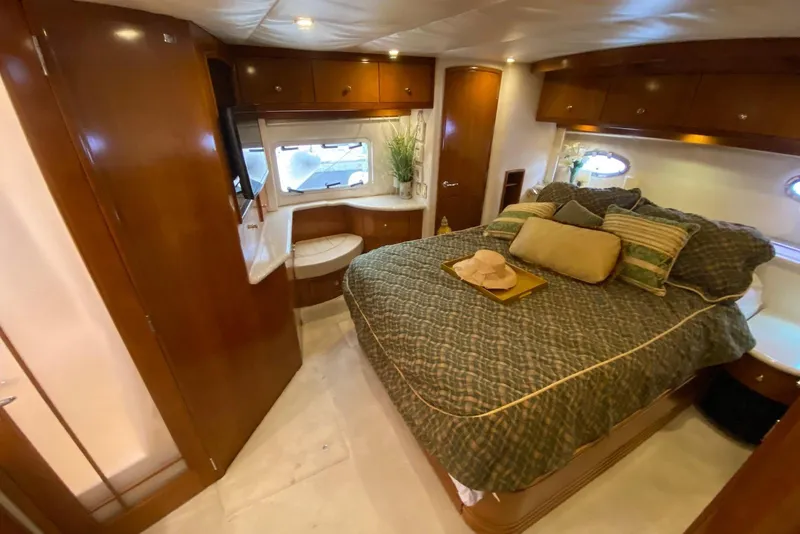 Slide: The Image of Luxurious bedroom interior of 2000 Carver 506 Motor Yacht with elegant wood finishes. - 35