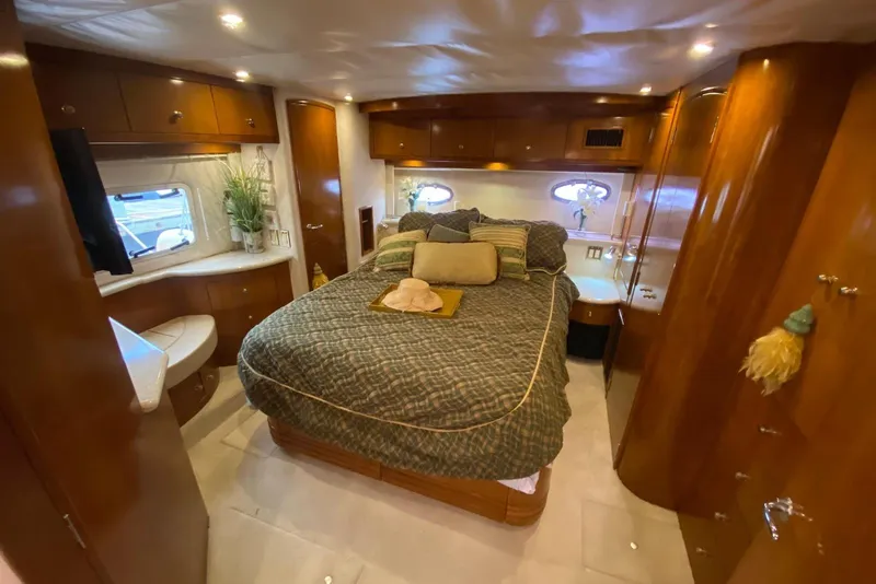 Slide: The Image of Luxurious bedroom interior of 2000 Carver 506 Motor Yacht with elegant wood finishes. - 36