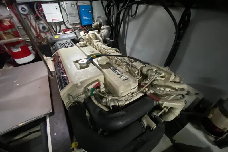 Slide: The Image of Engine room of a 2000 Carver 506 Motor Yacht, featuring a detailed engine view. - 43