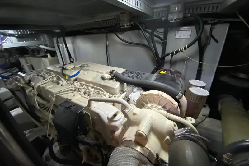 Slide: The Image of Engine room of a 2000 Carver 506 Motor Yacht, showcasing mechanical components. - 49