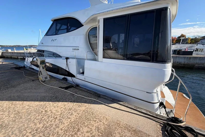 Slide: The Image of 2000 Carver 506 Motor Yacht docked at marina, side view. - 5