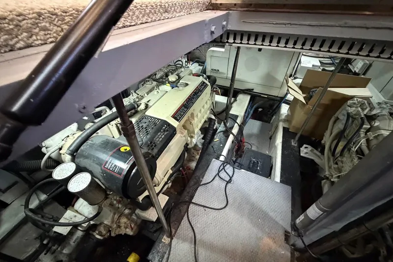 Slide: The Image of Engine room of a 2000 Carver 506 Motor Yacht, showcasing mechanical components and wiring. - 52