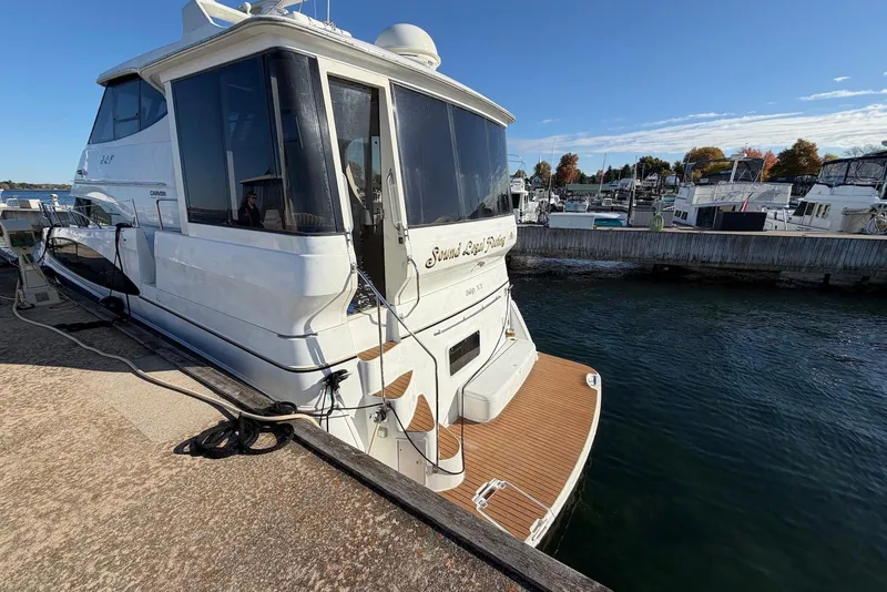 Slide: The Image of 2000 Carver 506 Motor Yacht docked at marina under clear blue sky. - 6