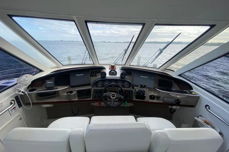 Slide: The Image of Interior view of 2000 Carver 506 Motor Yacht helm with panoramic windows and navigation equipment. - 8