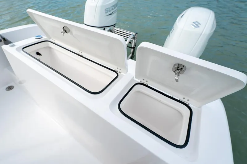 Slide: The Image of Manufacturer Provided Image: 2026 Twin Vee 240 STX CC boat with open storage compartments and Suzuki outboard motor. - 13