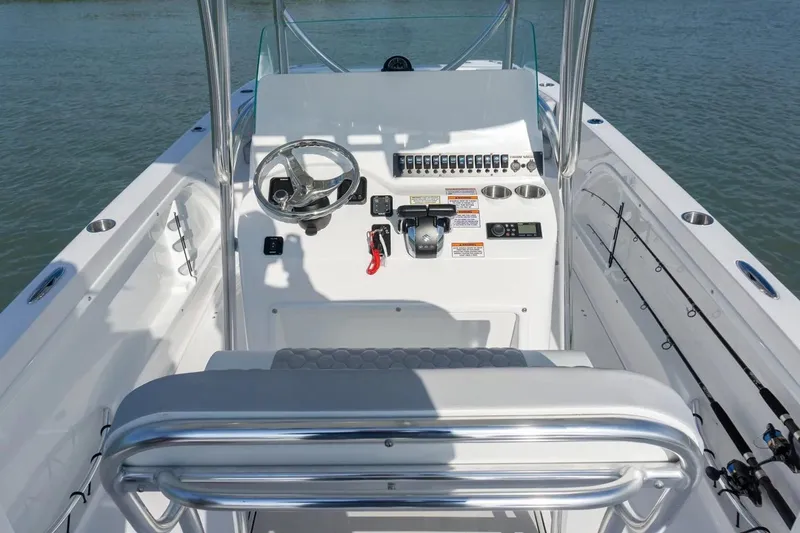 Slide: The Image of Manufacturer Provided Image: 2026 Twin Vee 240 STX CC boat console with steering wheel and controls on water. - 8