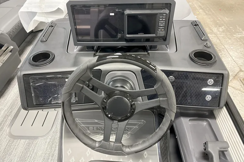 Slide: The Image of 2026 Bennington 23 M Swingback dashboard with steering wheel and Garmin display. - 12
