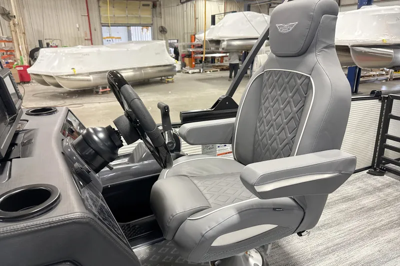 Slide: The Image of Captain's chair and helm of 2026 Bennington 23 M Swingback pontoon boat in a workshop. - 14
