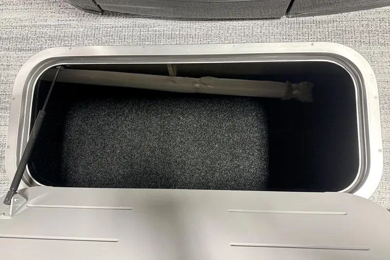 Slide: The Image of Storage compartment in 2026 Bennington 23 M Swingback boat, featuring carpeted interior. - 15