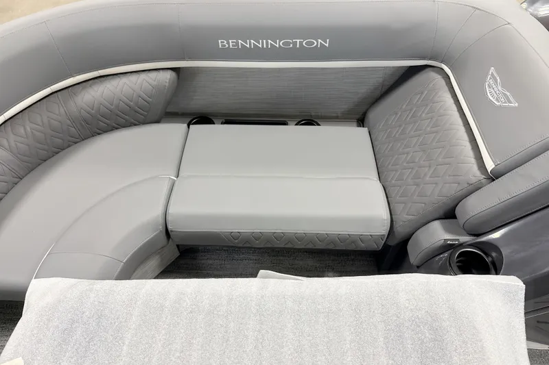 Slide: The Image of 2026 Bennington 23 M Swingback boat interior with luxurious gray seating and cup holders. - 9