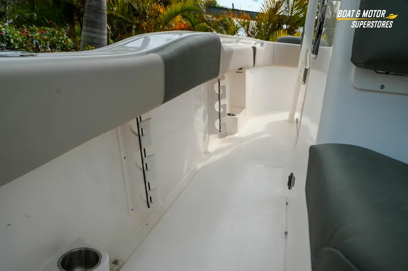 Slide: The Image of 2026 Key West 291 FS boat interior with cushioned seating and rod holders. - 12